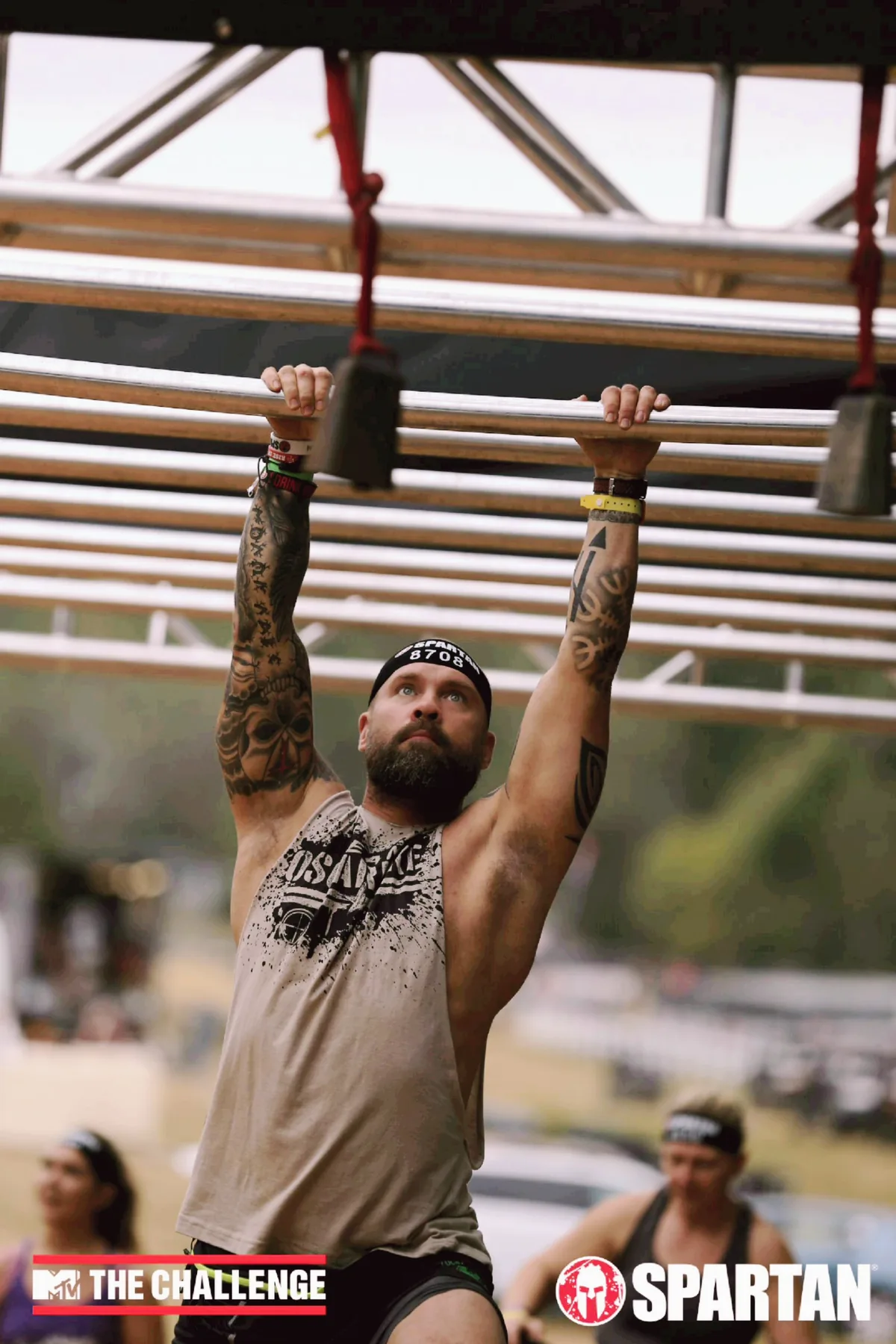 Coach Brian McMillian crossing monkey bars during a Spartan race
